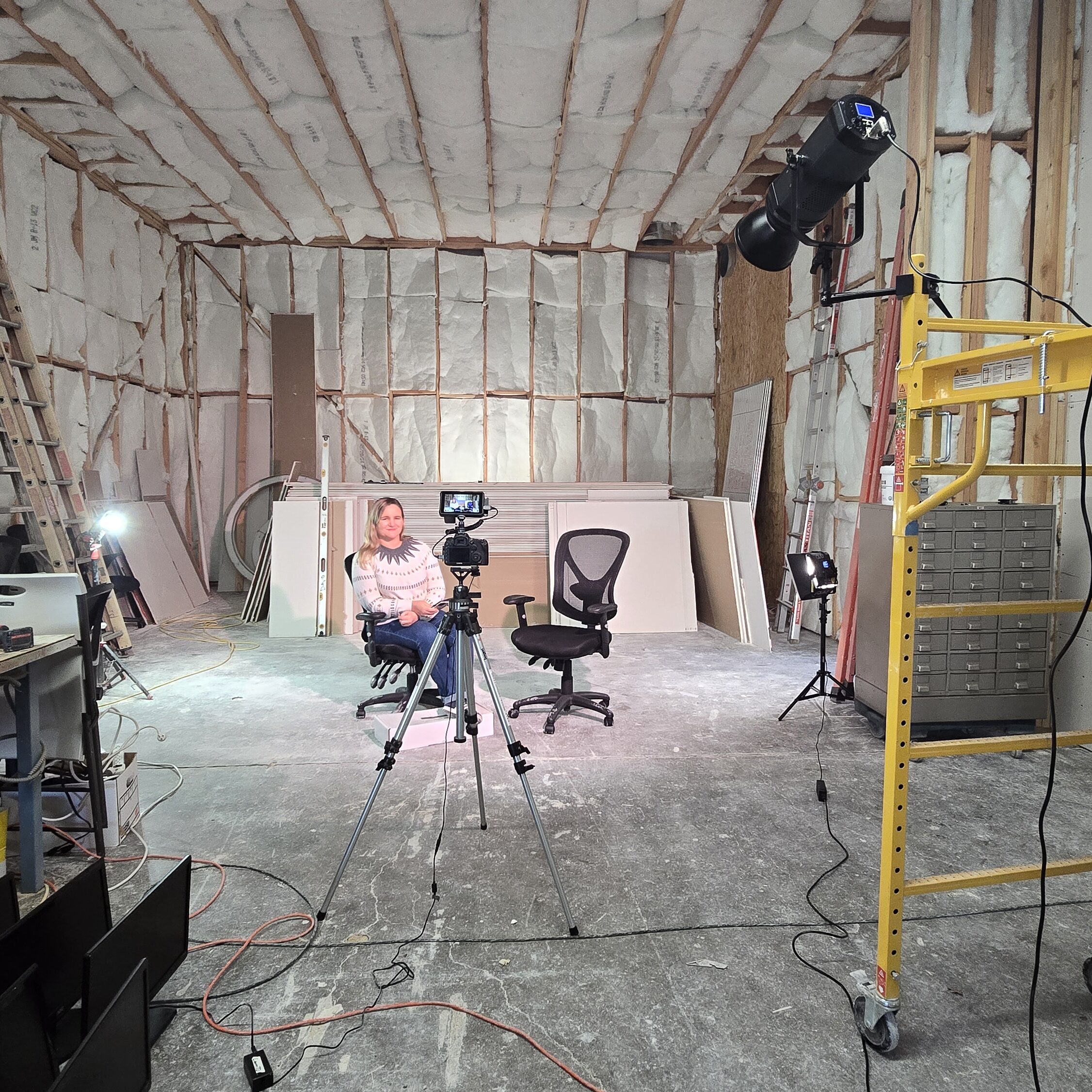 J4F Studio Virtual Production Room Tiphany Sitting in a chair ready to record in the unfinished space